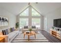 Bright living room features vaulted ceiling, large windows, and stylish black and white accents at 45 Kelsey Way, Palmetto, GA 30268