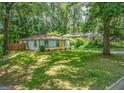 Exterior view shows a cozy one-story home with a spacious yard and mature trees for privacy at 1024 Regis Rd, Atlanta, GA 30315