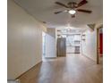 Open living area with modern flooring and updated ceiling fan adjacent to a kitchen featuring stainless appliances at 1024 Regis Rd, Atlanta, GA 30315