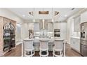 Spacious kitchen featuring grey cabinets, stainless steel appliances, marble countertops and a large island at 117 Via Roma, Woodstock, GA 30188