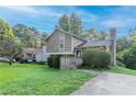 Charming two-story home with mature trees, landscaped front yard, and inviting front porch at 8670 Brandon Hill Ln, Jonesboro, GA 30238