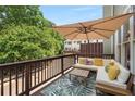 Cozy outdoor deck with comfortable seating and a large umbrella for shade at 106 Oakhurst Ter, Decatur, GA 30030