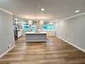 Bright living room featuring an open floor plan, recessed lighting, and stylish light fixtures over island at 1872 Canmont Ne Dr, Brookhaven, GA 30319