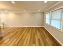 Bright open-concept room with modern flooring, light gray walls, and large windows offering ample natural light at 1872 Canmont Ne Dr, Brookhaven, GA 30319