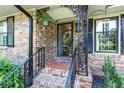 Inviting front porch with brick flooring, decorative ironwork, and classic architectural details at 2532 Millbrook Dr, Snellville, GA 30078