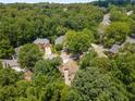 An aerial shot shows a large home nestled among mature trees in a peaceful residential neighborhood at 290 Edwardton Ct, Roswell, GA 30076