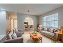Inviting living room with neutral tones, plush seating, and an archway that leads into dining area at 4748 Carson Sw Pass, Atlanta, GA 30331