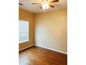 Cozy bedroom with hardwood floors, a ceiling fan, and a window at 301 Brookview Dr, Riverdale, GA 30274