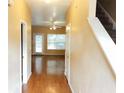 Inviting foyer leads into an open-concept living area with hardwood floors and a staircase on the right at 301 Brookview Dr, Riverdale, GA 30274