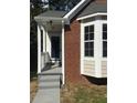 Charming brick home features a bay window, grey roof, and entrance at 3186 Kingswood Gln, Decatur, GA 30034