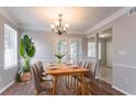 Inviting dining room with hardwood floors, a stylish chandelier, and French doors to the outside at 4968 Windsor Downs Ln, Decatur, GA 30035