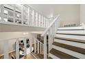 View of the wood-trimmed staircase with white railings leading to an open landing area at 2706 Del Ridge Dr, Douglasville, GA 30135