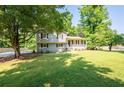 Shot of the two-story home with black shutters and a charming covered front porch at 2880 Brett Nw Cir, Acworth, GA 30101