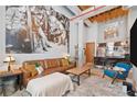 An open-concept living room with concrete pillars, wooden ceilings, and a modern kitchen at 650 Glen Iris Ne Dr # 26, Atlanta, GA 30308
