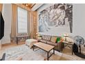 An industrially styled living room with high ceilings, exposed brick, and a large movie mural at 650 Glen Iris Ne Dr # 26, Atlanta, GA 30308