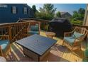 Cozy outdoor deck with comfortable seating, a fire table, and a grill at 730 Midway Ave, Canton, GA 30114
