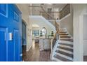 Elegant foyer with hardwood floors, a staircase with iron railings, and a view into the living area at 85 Shiver Blvd, Covington, GA 30016