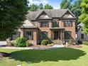 Beautiful brick home with manicured lawn and lush landscaping in a desirable neighborhood at 2539 Sagebrush Trl, Buford, GA 30519