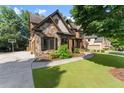Brick and stone home featuring a basketball court and well-maintained landscaping at 2539 Sagebrush Trl, Buford, GA 30519