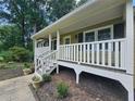 Inviting front porch featuring classic white railings and trim, offering a cozy outdoor space at 312 N Briar Rdg, Woodstock, GA 30189