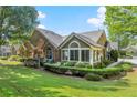 Beautiful backyard with manicured lawn, stone and siding exterior, and inviting patio space at 5228 Stone Village Circle Northwest #14 Nw Cir # 14, Kennesaw, GA 30152