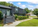 Inviting front entrance featuring well-maintained landscaping and a walkway, enhancing the home's charm at 110 Village Ct, Woodstock, GA 30188