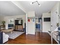 Open-concept living room featuring hardwood floors, and an adjacent kitchen for seamless entertaining at 110 Village Ct, Woodstock, GA 30188