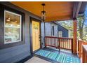 Close up view of the covered front porch featuring a stylish rug and a yellow door at 1336 Mcclelland Ave, Atlanta, GA 30344