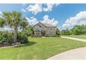 Well-maintained two-story home with lush green lawn, mature trees, and a circular driveway at 1405 Rainey Way, Hampton, GA 30228