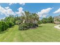Expansive front yard with mature trees and manicured landscaping framing a beautiful two-story home at 1405 Rainey Way, Hampton, GA 30228