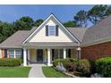 Charming front exterior showcasing a lovely porch, manicured landscaping, and classic architectural elements at 964 Natural Brook Trl, Lawrenceville, GA 30045