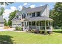 Attractive two-story home featuring a covered porch, two-car garage, and lush green lawn at 20 Scarlett Oak Ne Dr, Cartersville, GA 30121