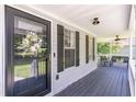 Inviting covered front porch featuring a dark wood floor, ceiling fans, and charming decor at 20 Scarlett Oak Ne Dr, Cartersville, GA 30121