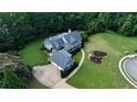 Large private lot featuring a home with a detached garage, long driveway, and landscaping, all backing to woods at 200 Chaparral Trce, Tyrone, GA 30290
