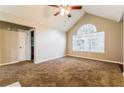 Bright bedroom featuring carpet, ceiling fan, vaulted ceiling and large window at 3163 Springside Xing, Decatur, GA 30034