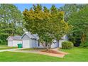 Landscaped front yard of a well-maintained single-story home with mature tree at 3163 Springside Xing, Decatur, GA 30034
