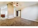 Spacious living room featuring neutral paint, carpet, and a fireplace with view into kitchen at 3163 Springside Xing, Decatur, GA 30034