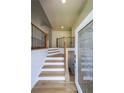 Welcoming foyer with hardwood stairs, black iron railing, and decorative glass front door at 503 Rising Dr, Woodstock, GA 30189
