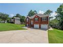 A brick-fronted home with a two-car garage, a well-maintained lawn, and a classic arched entryway at 503 Rising Dr, Woodstock, GA 30189