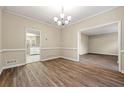 Neutral dining room featuring hardwood floors, chair rail detail, and ample natural light at 2004 Township Dr, Woodstock, GA 30189
