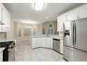 Bright eat-in kitchen featuring white cabinets, granite countertops, and stainless steel appliances at 2004 Township Dr, Woodstock, GA 30189