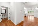 Open-concept entryway with hardwood floors and views into the kitchen, dining, and powder room at 3541 Ashcroft Se Dr, Smyrna, GA 30080