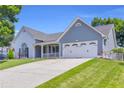 Two-story home with a well-maintained lawn and a spacious driveway at 499 Running Doe Ct, Suwanee, GA 30024