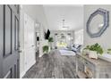 Open-concept living room with hardwood floors and natural light at 499 Running Doe Ct, Suwanee, GA 30024
