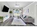 Bright living room featuring a large window and comfortable seating at 499 Running Doe Ct, Suwanee, GA 30024