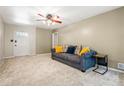 Cozy living room with neutral carpet, ceiling fan, and bright front door at 824 Hickory Ridge Sw Rd, Lilburn, GA 30047