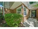 Inviting brick facade with lush green bushes, and a black front door for a welcoming entrance at 22 Dunwoody Springs Dr, Atlanta, GA 30328