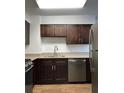 A kitchen featuring stainless steel appliances, brown cabinets, and light-colored countertops at 2479 Peachtree Ne Rd # 317, Atlanta, GA 30305