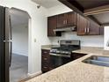Kitchen showcasing stainless steel appliances, granite countertops and wooden cabinetry at 2479 Peachtree Ne Rd # 317, Atlanta, GA 30305
