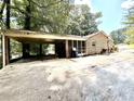 Spacious carport area connected to the brick home, with a basketball hoop in the driveway at 3006 East Point Street, East Point, GA 30344